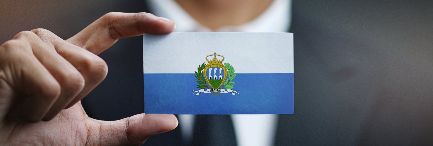 Businessman holding card of san marino flag