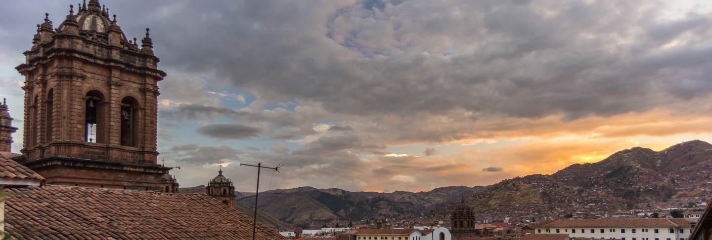 Sunset over cusco, peru, with storm clouds