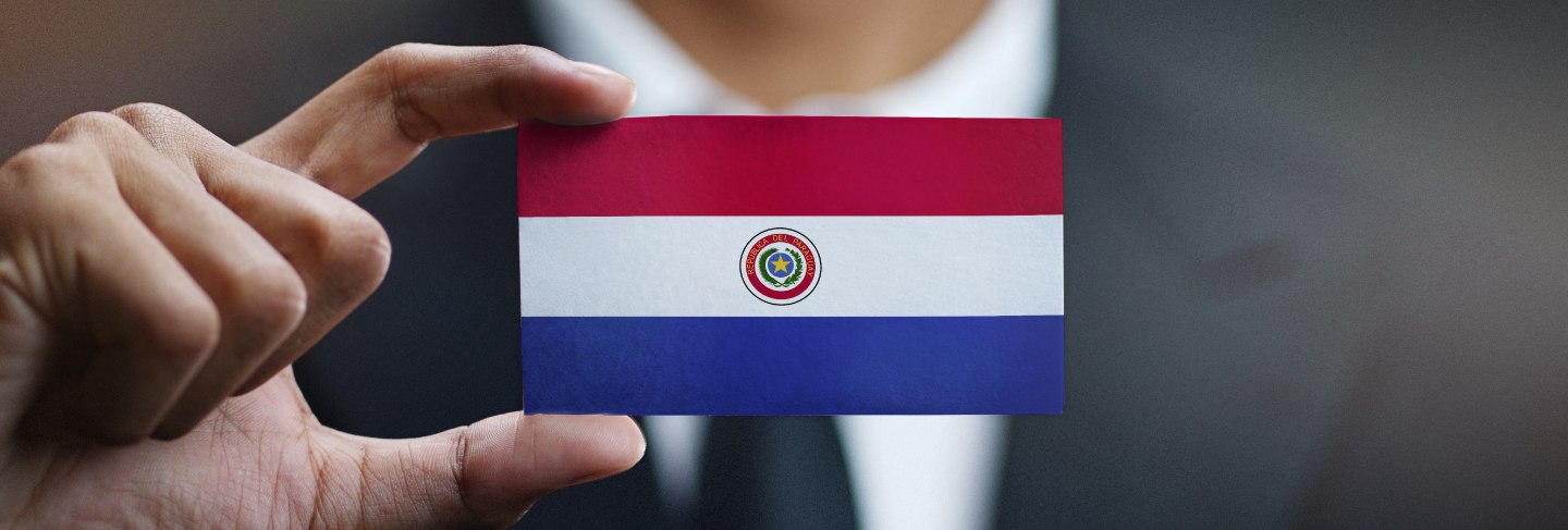 Businessman holding card paraguay flag
