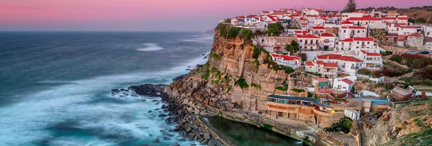 Sunset in the town azenhas do mar. with natural pool.