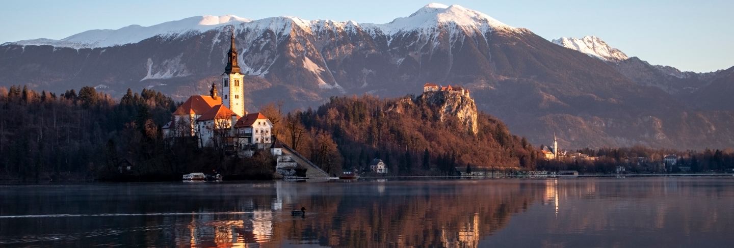 Bled lake a early winter morning in sunrise with the view of the island