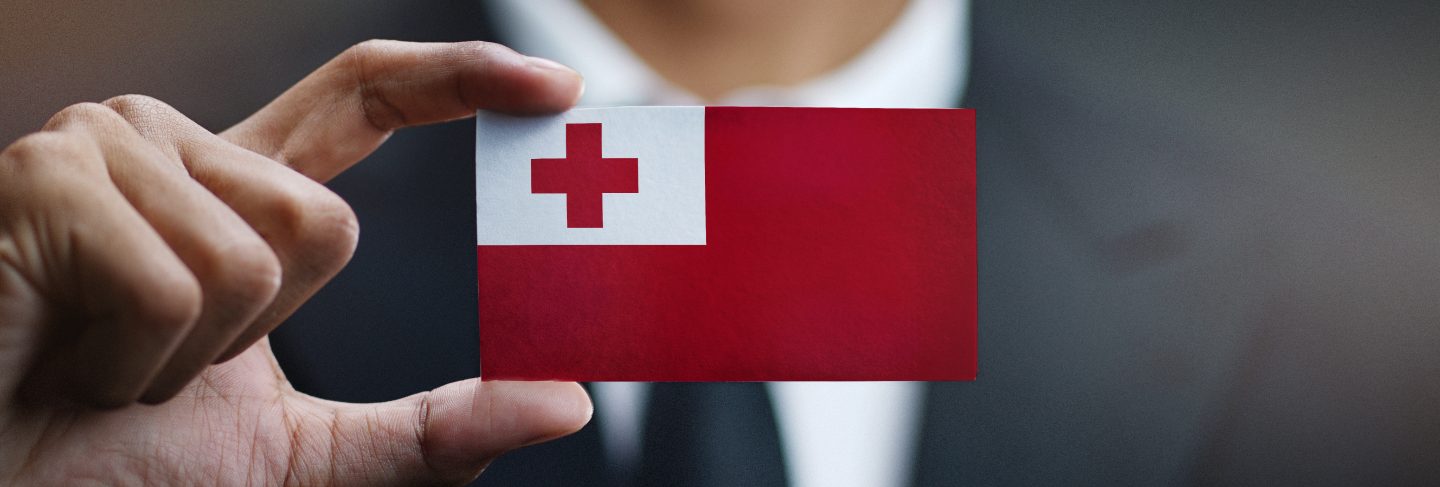 Businessman holding card of Tonga flag