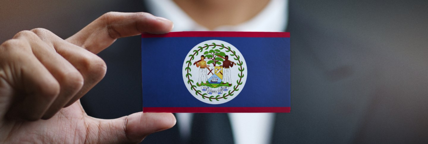 Businessman holding card of Belize flag