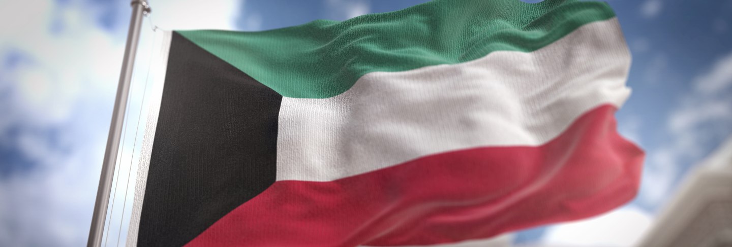 Kuwait flag 3d rendering on blue sky building background