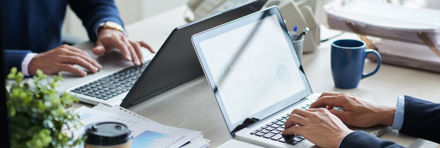Side view of cropped unrecognizable business people working at common desk