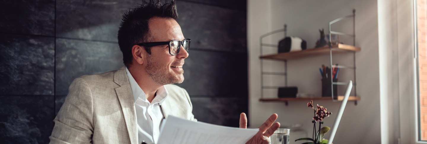 Businessman having online meeting in his office