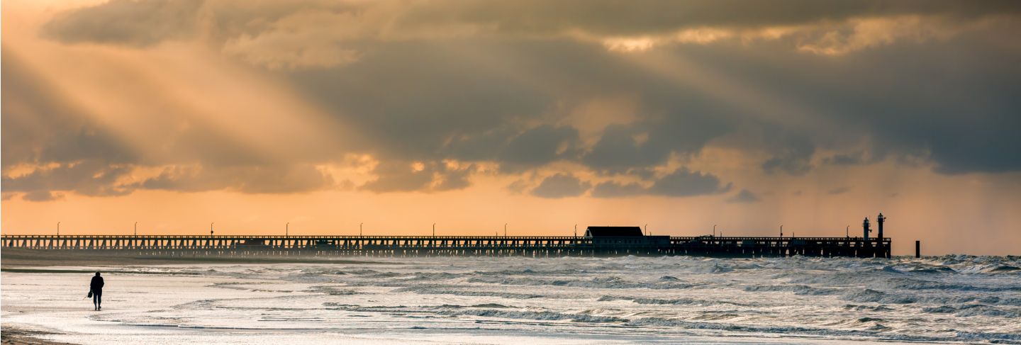 Walk on the beach to the palace pier at blankberg (belgium) on the fascinating north sea