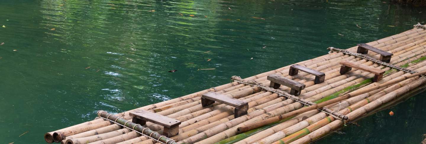 Bamboo raft a way to travel by water. the human used since ancient times. waterfall in tha