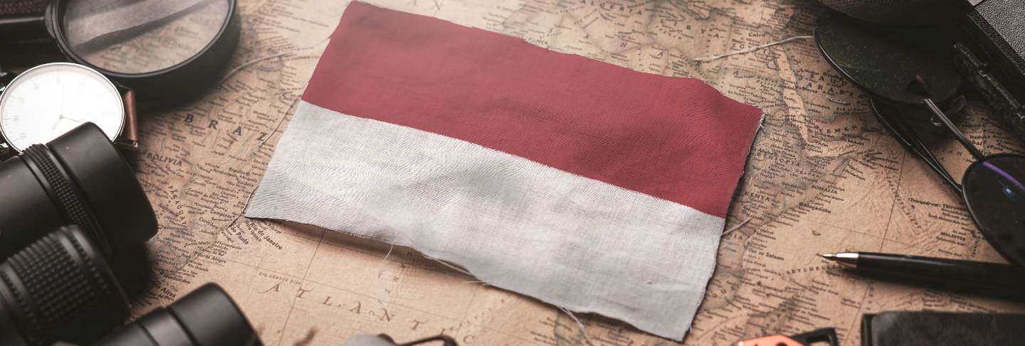 Indonesia flag between traveler's accessories on old vintage map. tourist destination concept