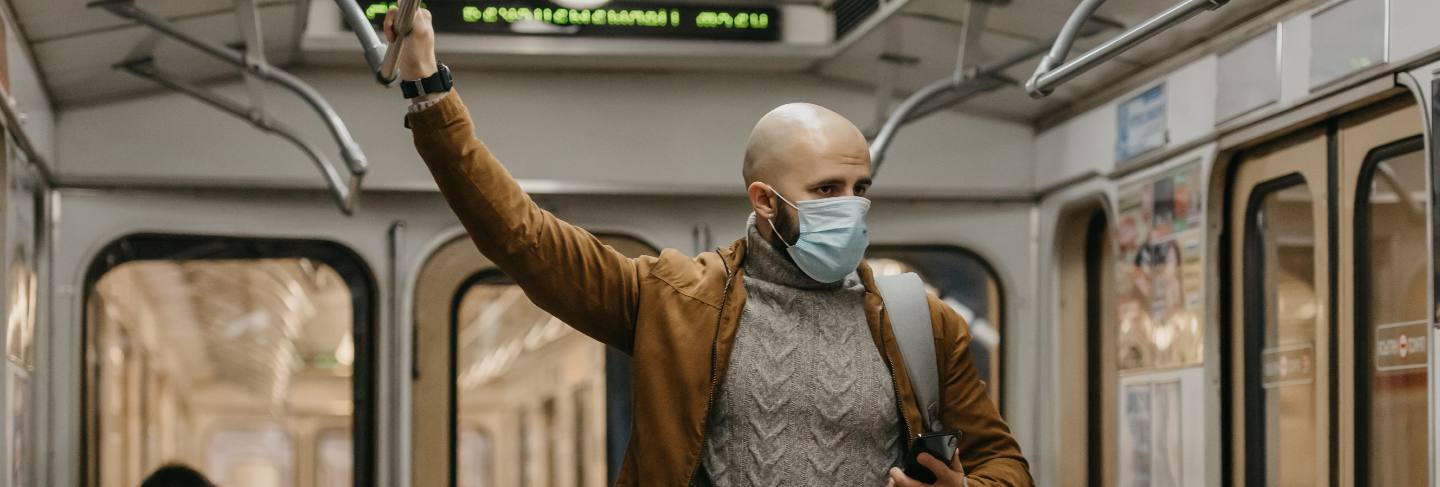 A man in a medical face mask at the subway station
