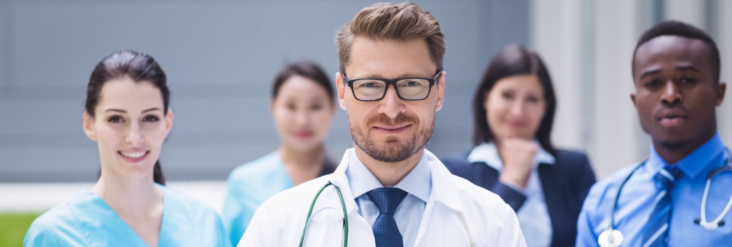Team of young specialist doctors standing in the corridor of the hospital