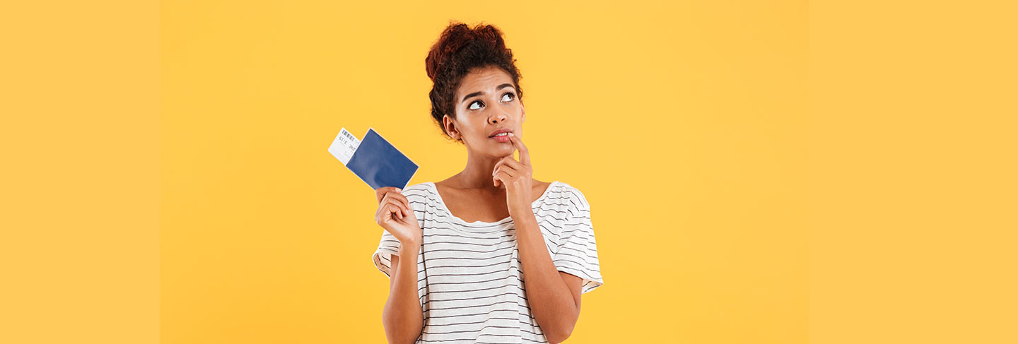 Thoghtful woman holding international passport isolated over yellow