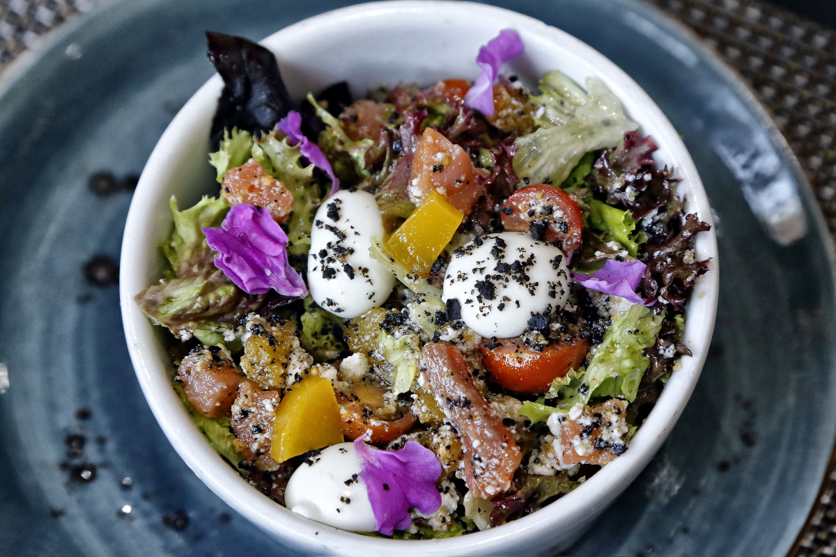La ensalada de salmón de uga, con lechuga, tomate cherry, requesón, aceitunas y millo tostado La ensalada de salmón de uga, con lechuga, tomate cherry, requesón, aceitunas y millo tostado