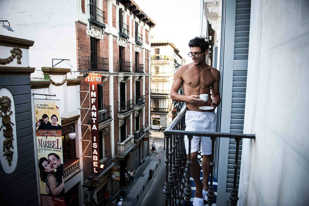 Hombre en el balcón de una de las habitaciones del hotel tomando un café Hombre en el balcón de una de las habitaciones del hotel tomando un café
