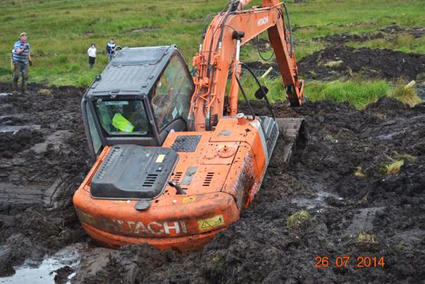 Drama as digger rescued from bog