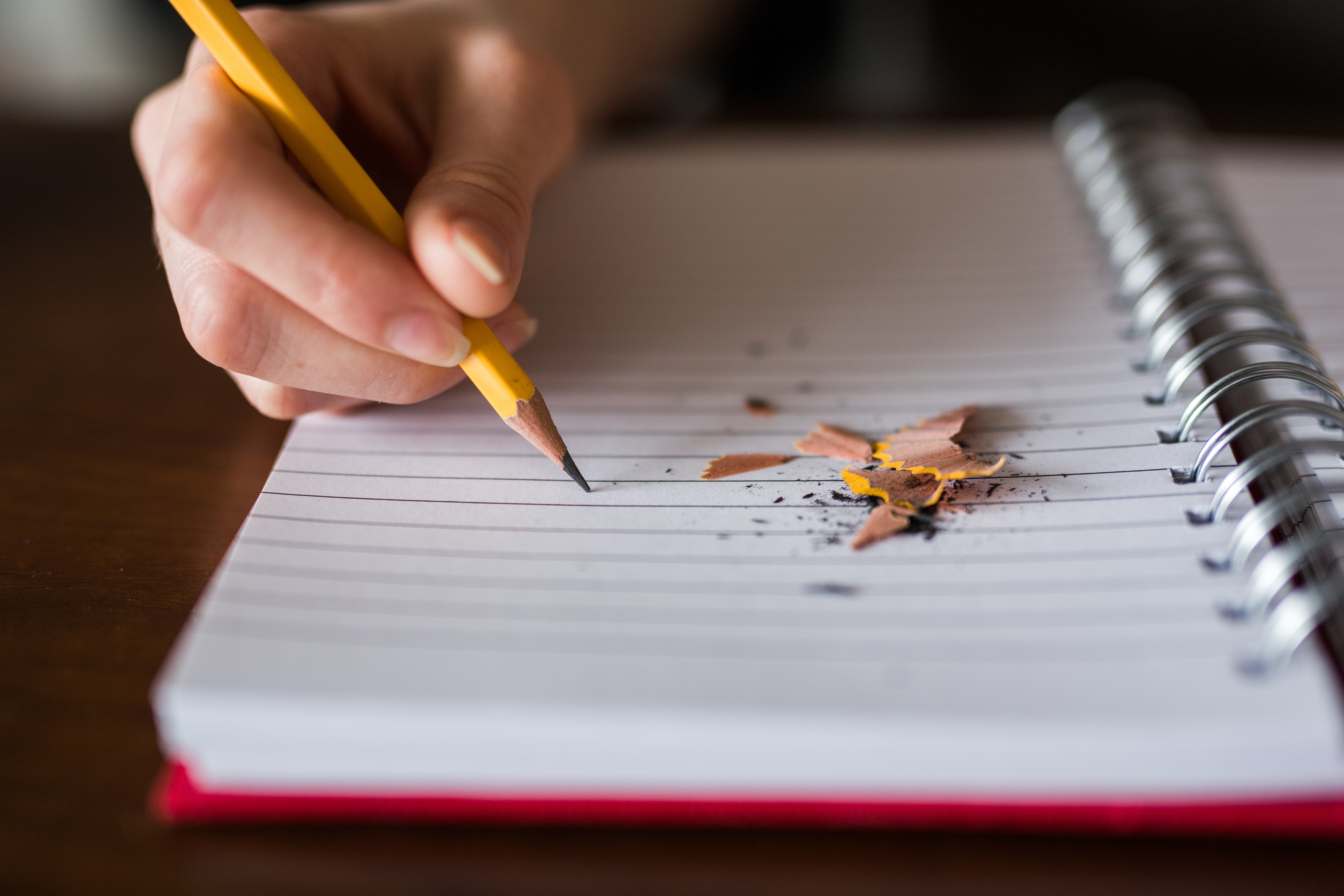 Photo of a child writing in a note pad
