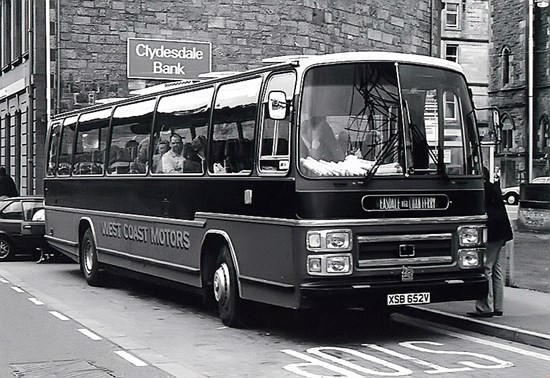 black and white photo of 1980s bus