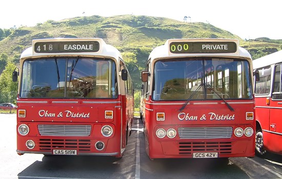 two red buses side by side reading Oban and District