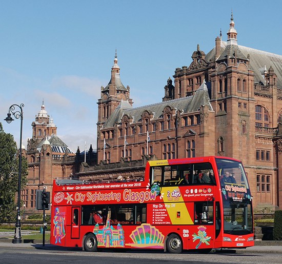 red open top bus outside Kelvingrove Art Gallery