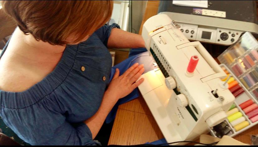 woman bent over sewing machine