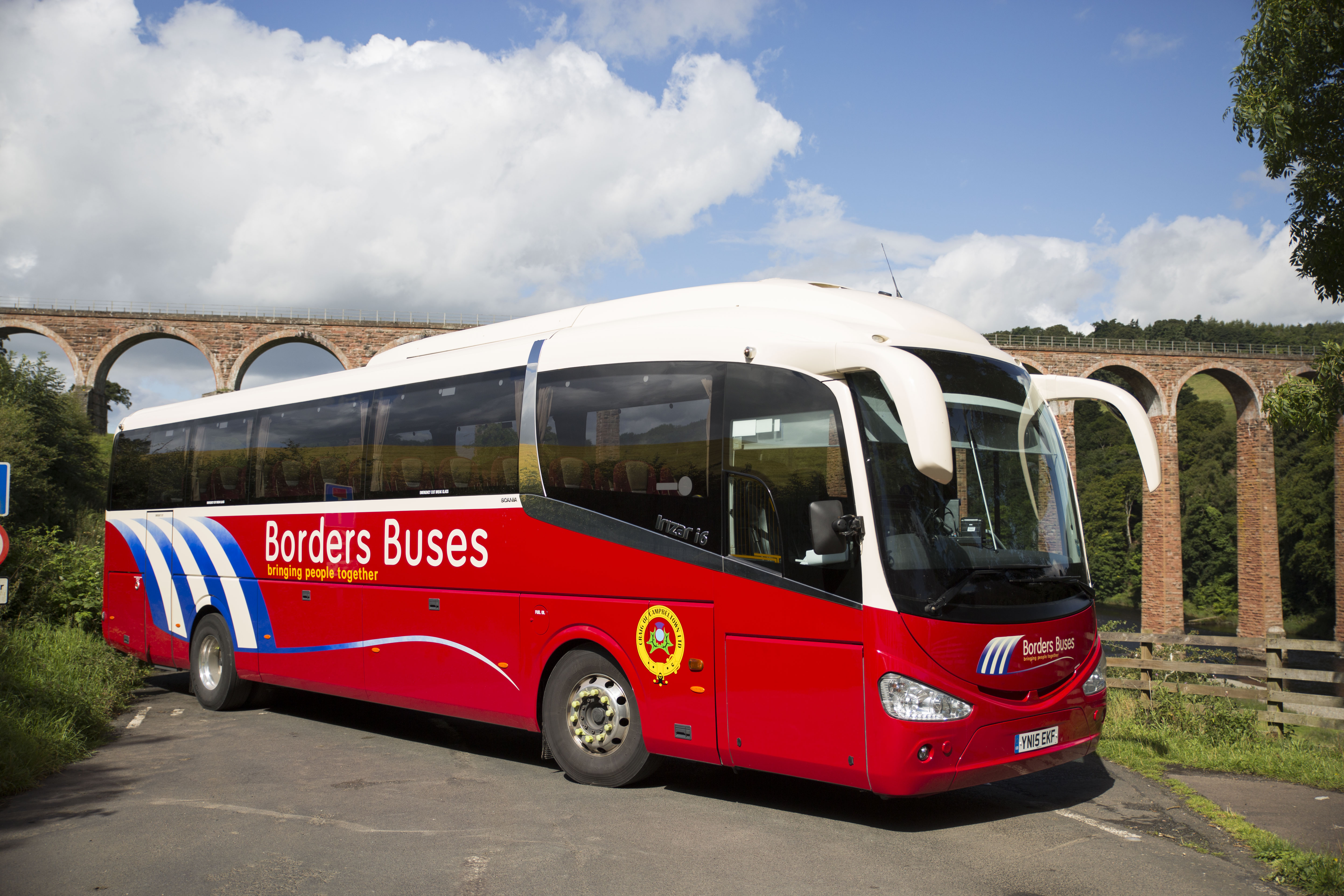 red coach in front of Galafoot Bridge