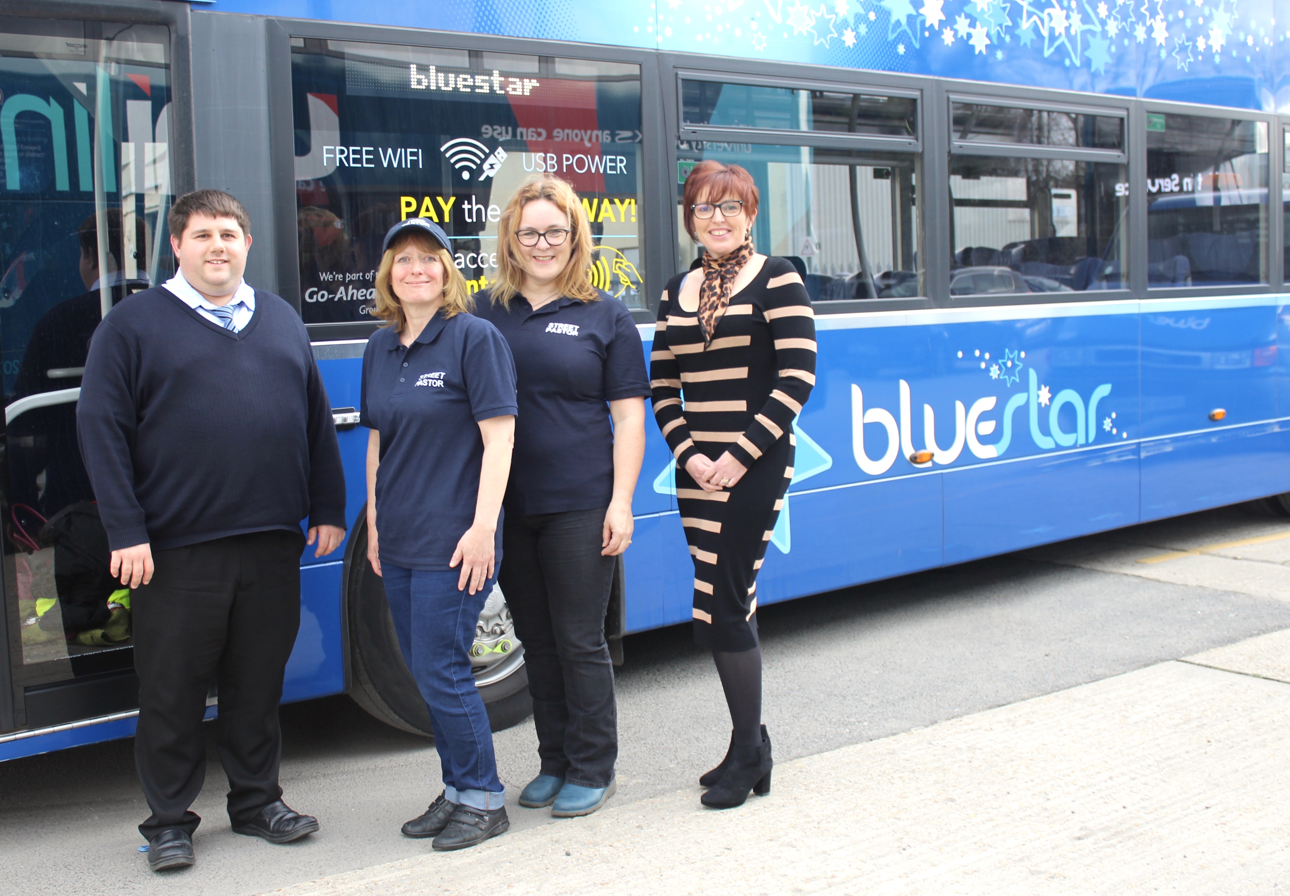 Photo of members from Waterside Street Pastors and Bluestar standing in front of a Bluestar Bus