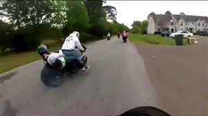 Girl falls onto motorbike tyre