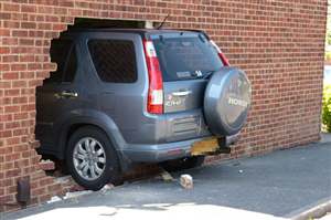 Car Crashes Through House