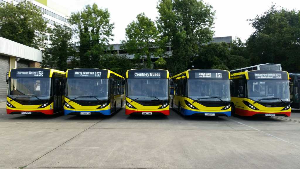 A row of 5 Courtney buses in the depot