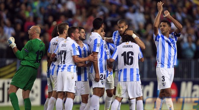 שחקני מלאגה חוגגים על מילאן (רויטרס)