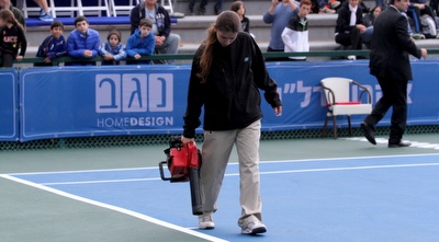 אנשי מרכז הטניס מייבשים את המגרש (יניב גונן)