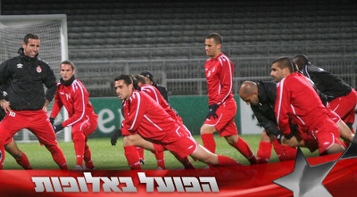 שחקני הפועל תל אביב מותחים איברים באימון המסכם (האתר הרשמי של הפועל ת&qout;א)