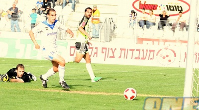 בן לולו מסתכל על הכדור מתגלגל לעבר הקורה, עמוס כבר על הדשא (משה חרמון)