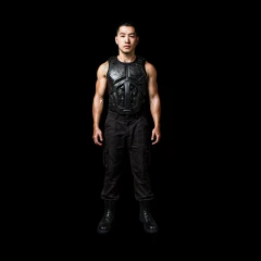 Muscular man in body armor and black pants.