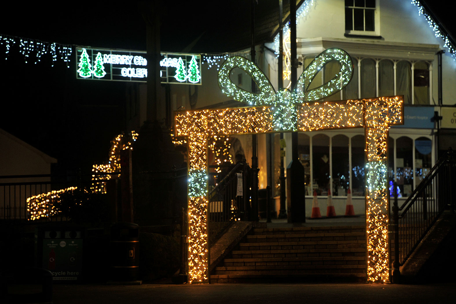 Gift box arch at the bottom of steps in a town square