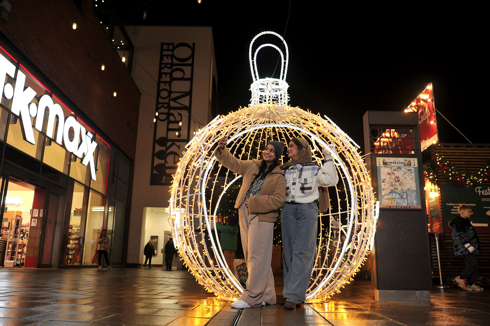 Christmas walk-through bauble with two young women taking a selfie inside