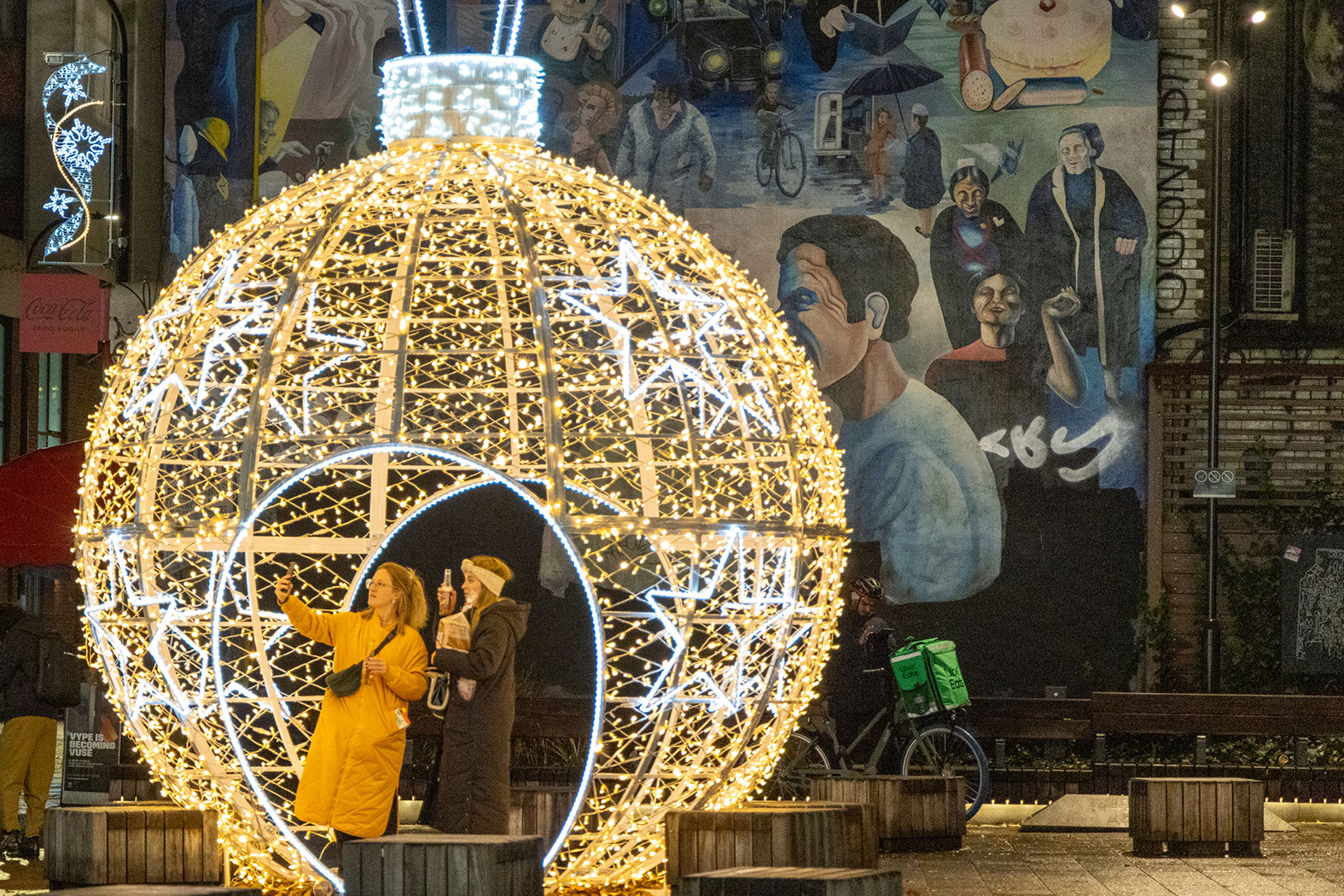 Large Christmas walk-through bauble with two young women taking a selfie inside
