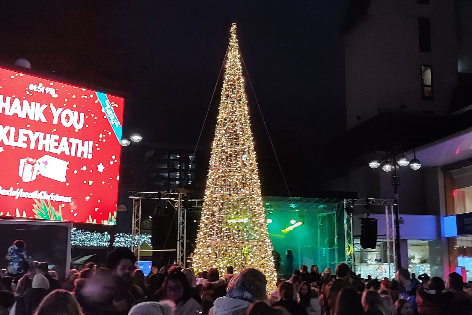 Warm white cone tree in a busy shopping square