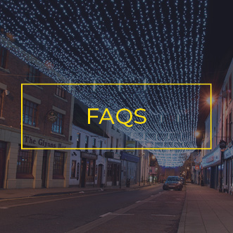 Large festive light ceiling covering a town shopping street