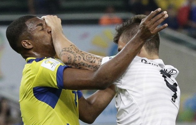 France's Olivier Giroud, right, clashes with Ecuador's Frickson Erazo, left, during the Group E World Cup match between Ecuador and France.