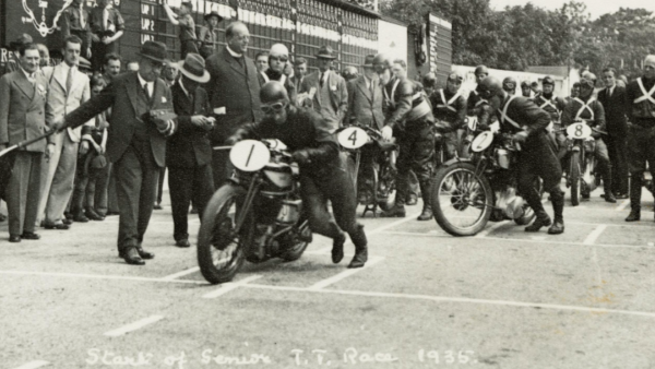 Image: Start of 1935 Senior TT, with the Manx Scouts updating the scoreboard in the background