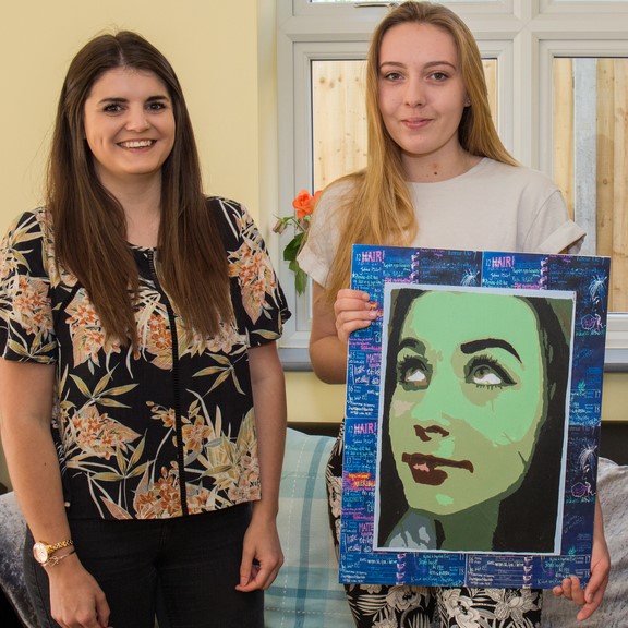 Caitlin-a-resident-at-Reading-Road-proudly-showcases-artwork-with-support-worker-Katie