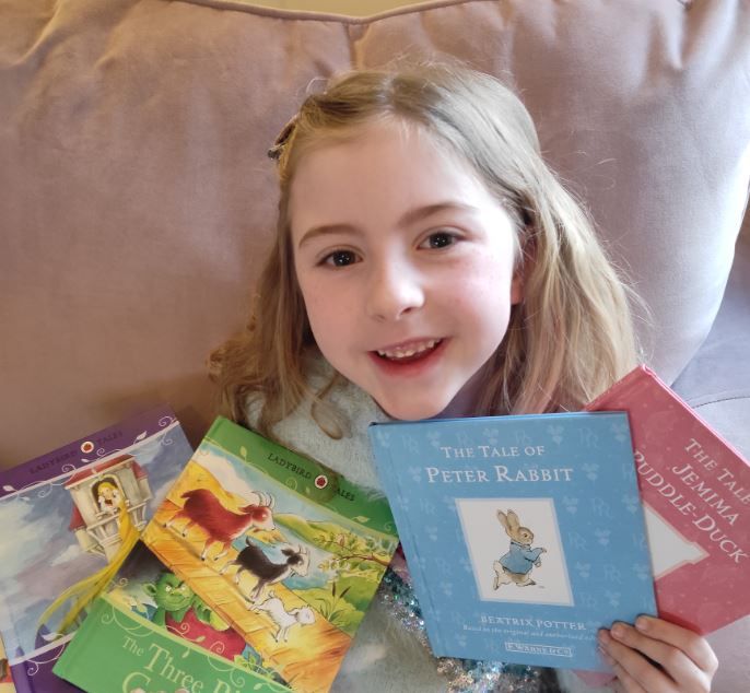 Bancyfelin six-year-old's book reading challenge to raise money for Wales Air Ambulance