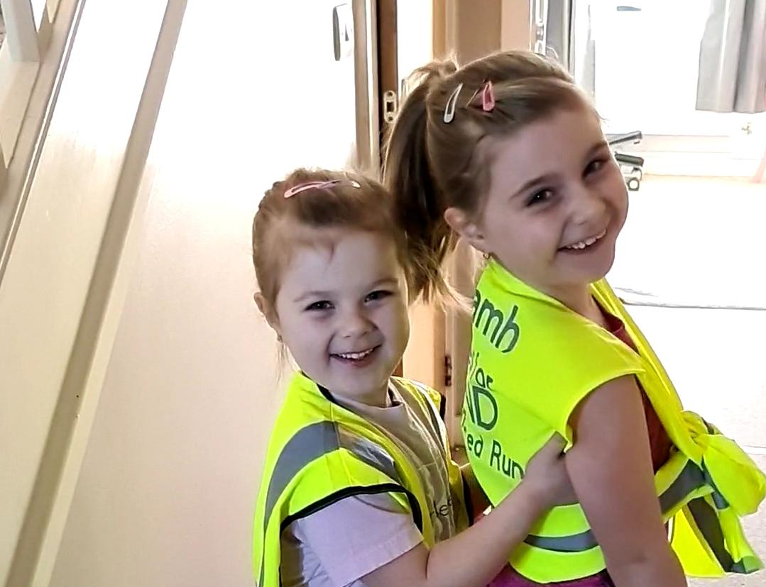 Young sisters run a mile a day to thank the charity that helped them understand Covid