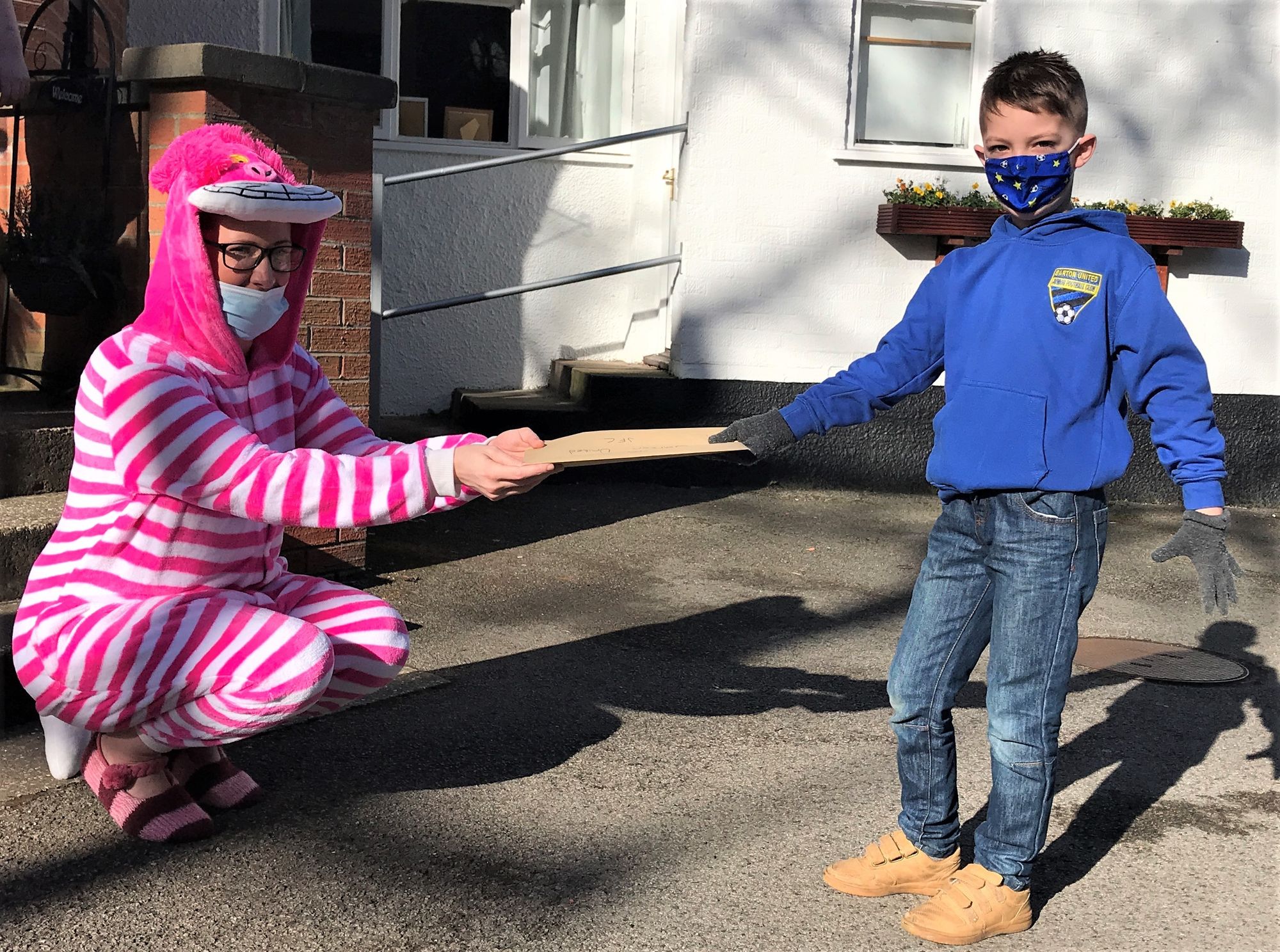 Care home residents receive World Book Day surprise from junior football players