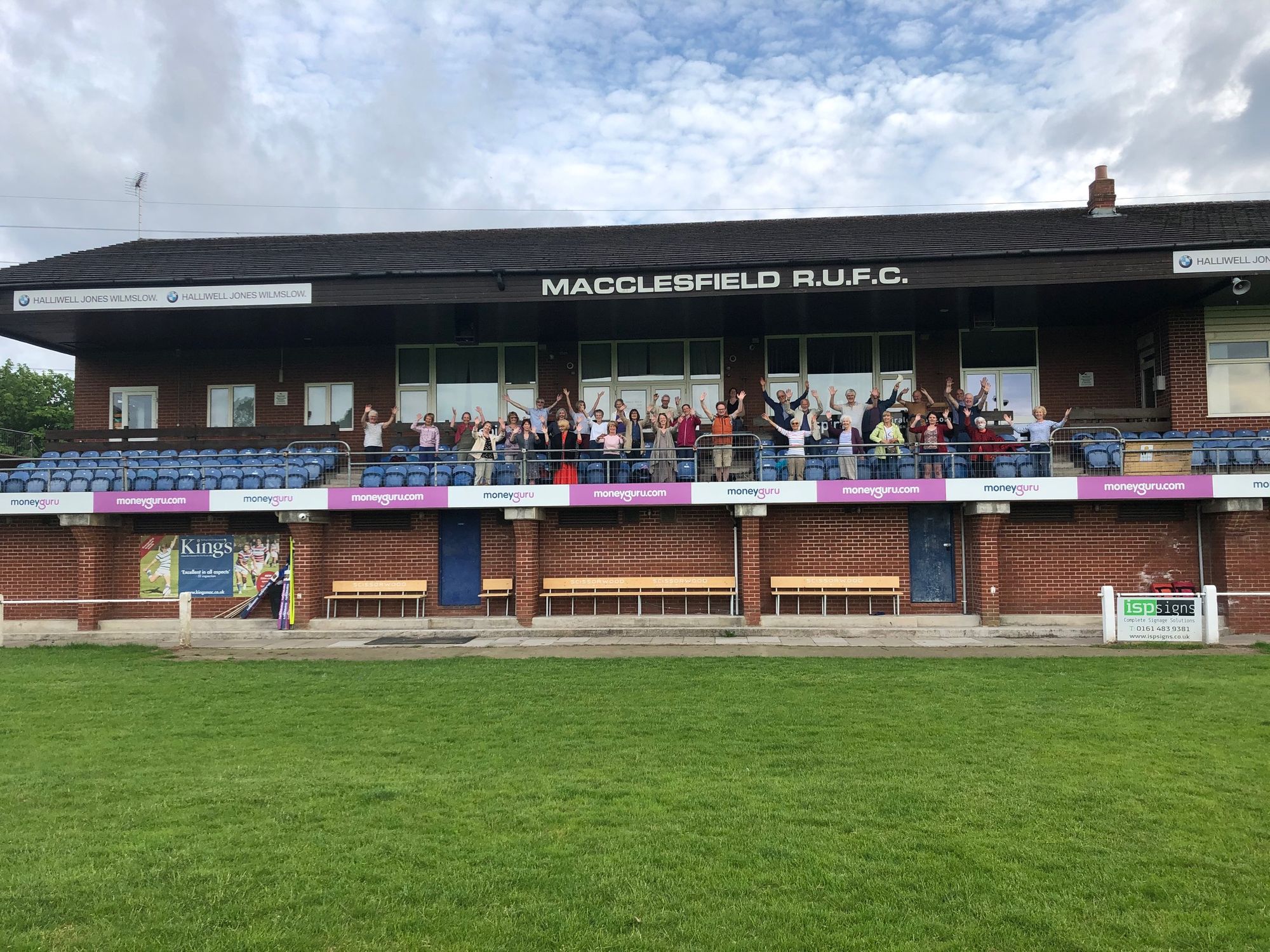 Choir tune up at new rehearsal spot - a rugby club stand