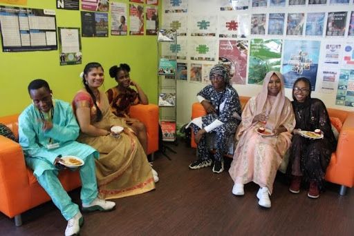 Students and staff dressed in traditional outfits from their cultures.