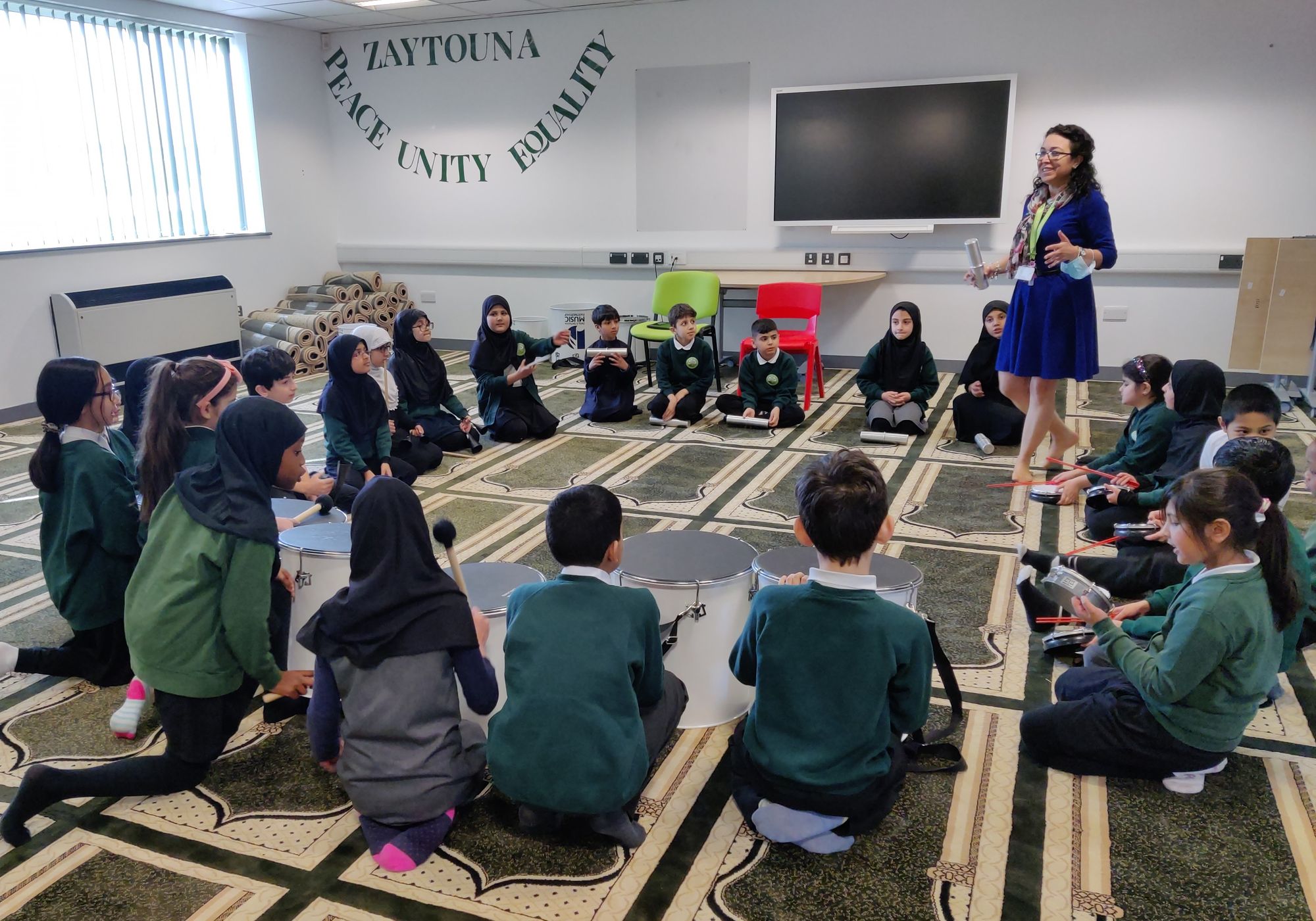 Pupils at Zaytouna Primary School bang the drum for Derby Music Partnership