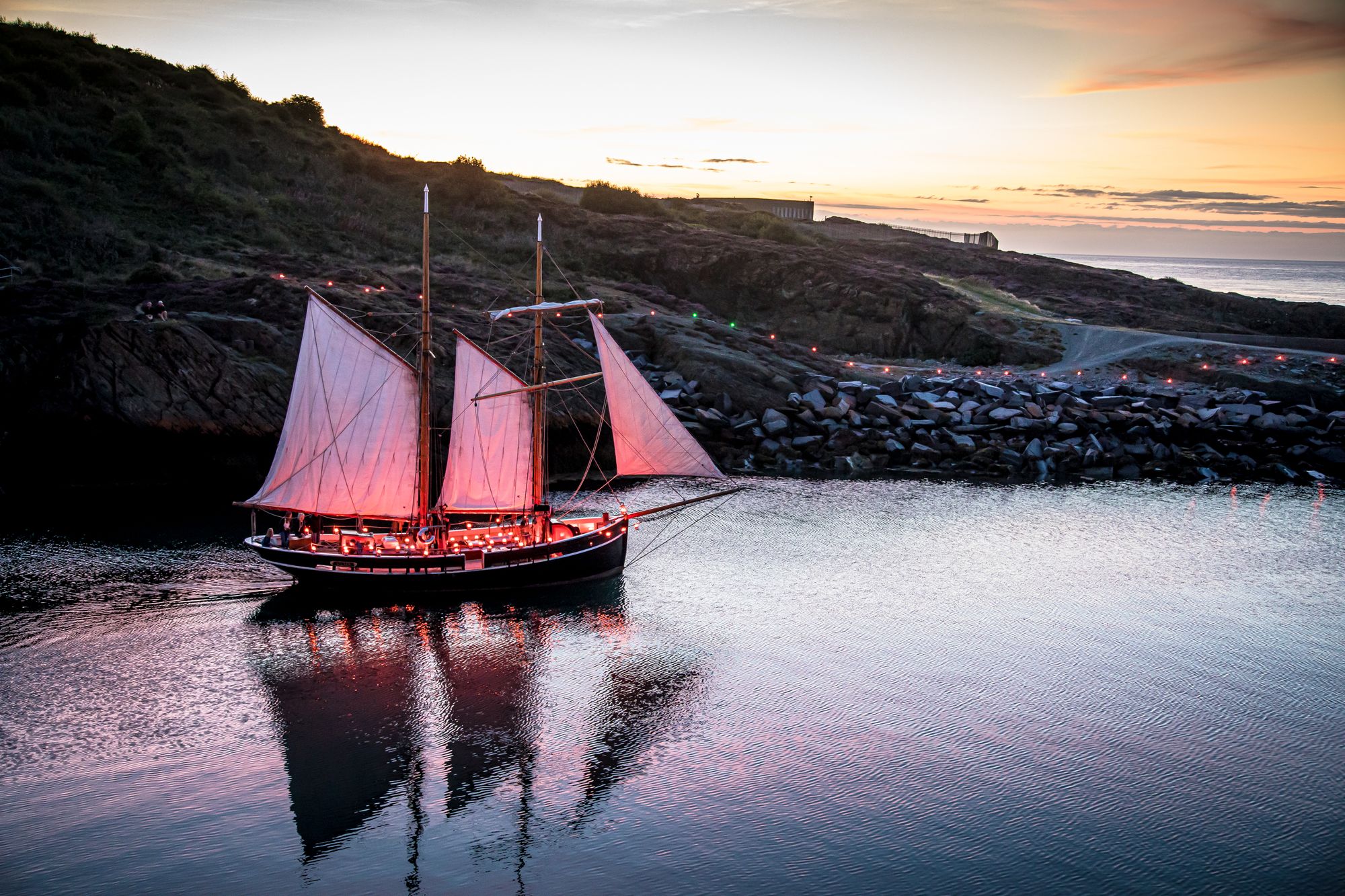 Local residents create an illuminated trail on Anglesey's Copper Mountain and Amlwch Port