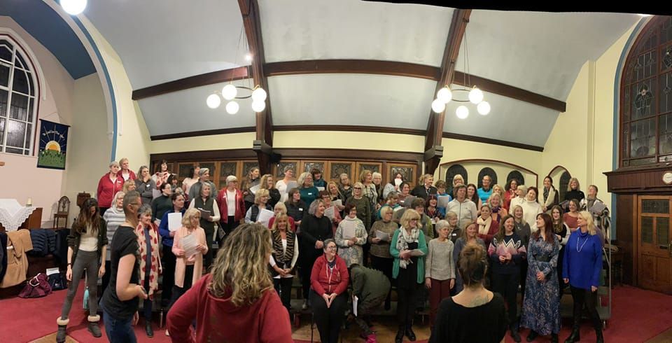 New members of Stockport women's barbershop chorus practise for Romiley Forum show